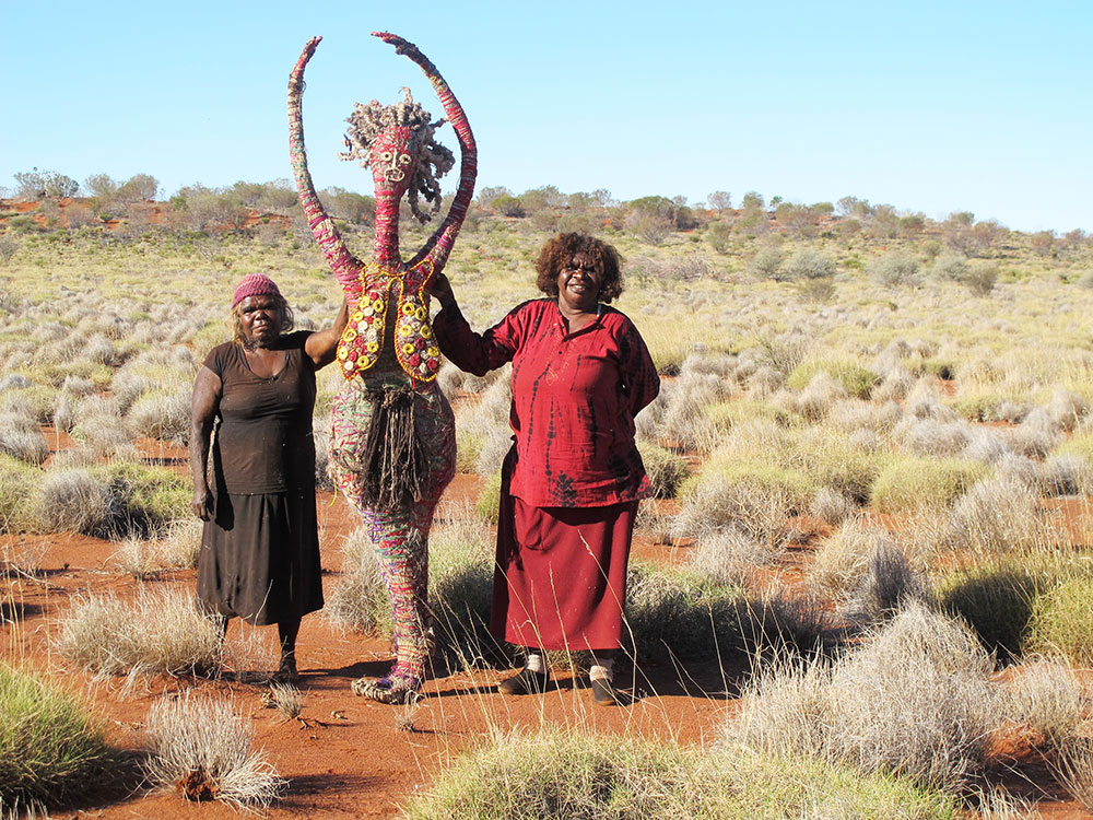 'Angilyiya Tjapiti Mitchell and Paula Sarkaway Lyons show off the oldest of the Seven Sisters. This sister is <em>ninti</em> (knowledgeable) and always recognises Wati Nyiru’s tricks, such as when he transforms himself into a delicious quandong or snake to entice the sisters to eat him.'
