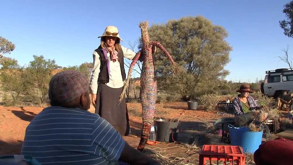 'Janet and Jo Foster, of Tjanpi Desert Weavers, discuss what to add next to shape the sister and give her personality.'